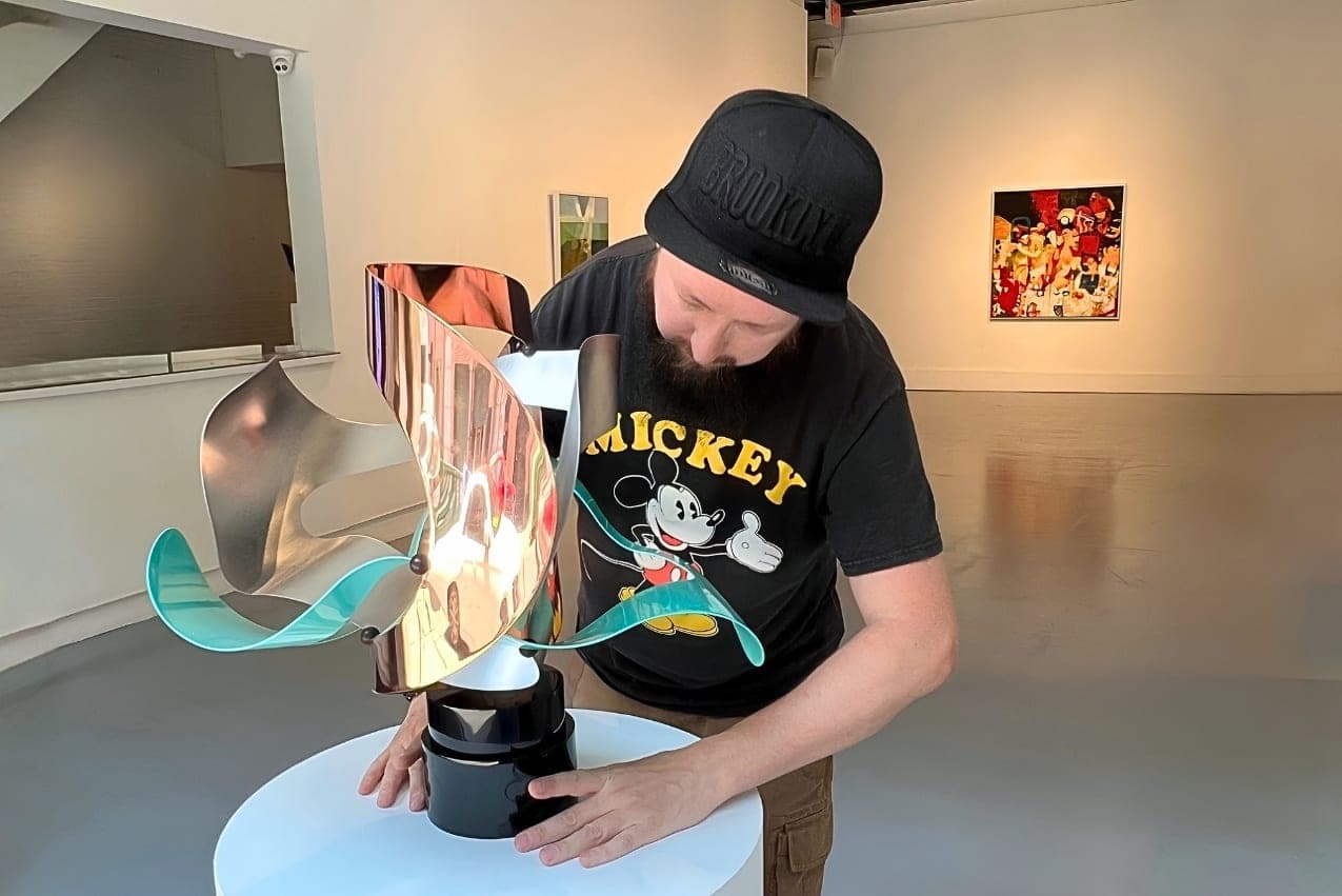 Gallery installer handling an artwork during an exhibition installation at Agora Gallery.