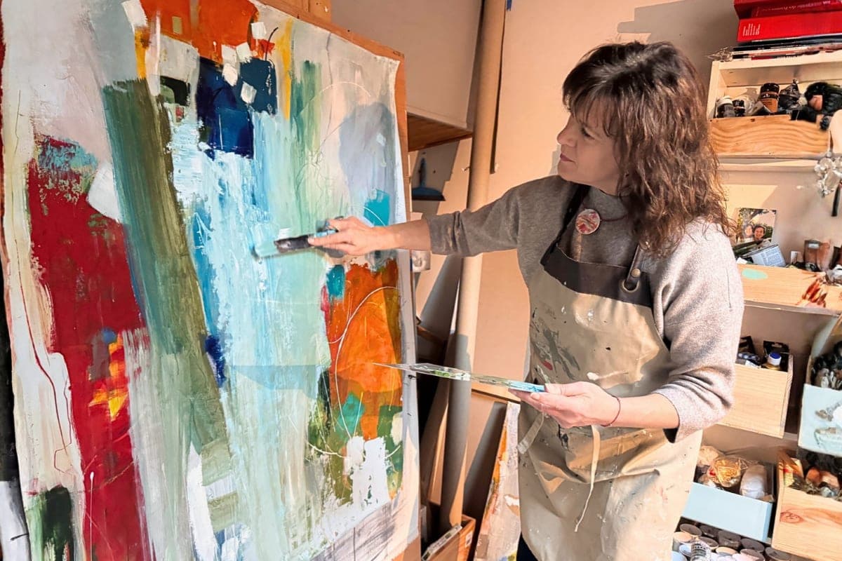 Artist Isabelle de Marco working on a large abstract painting in her home studio