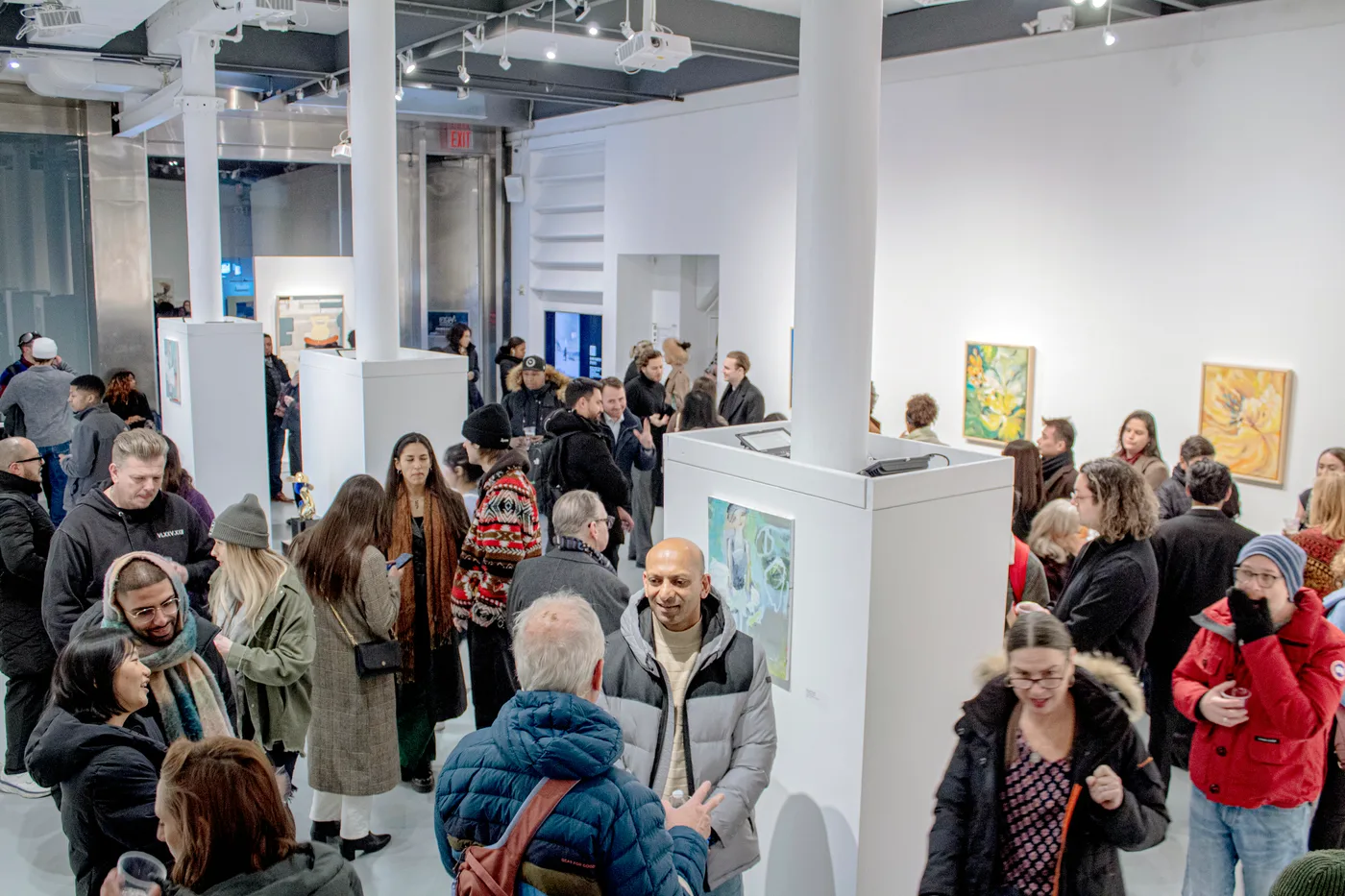 Visitors filling the gallery at the A New Gotham opening reception, Agora Gallery, January 2025