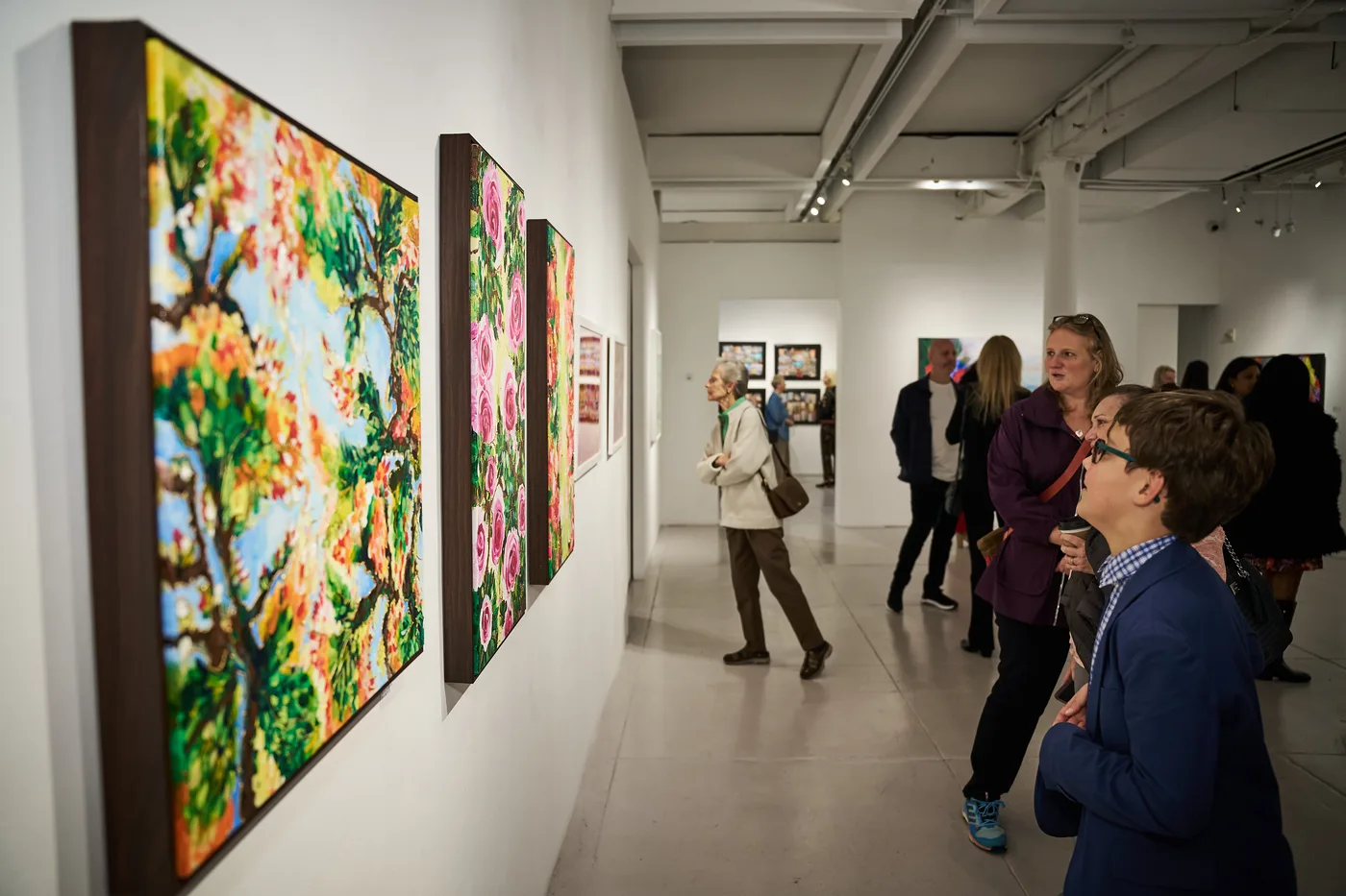 Guests viewing works along the gallery wall at the New York I Love You opening reception, October 2025