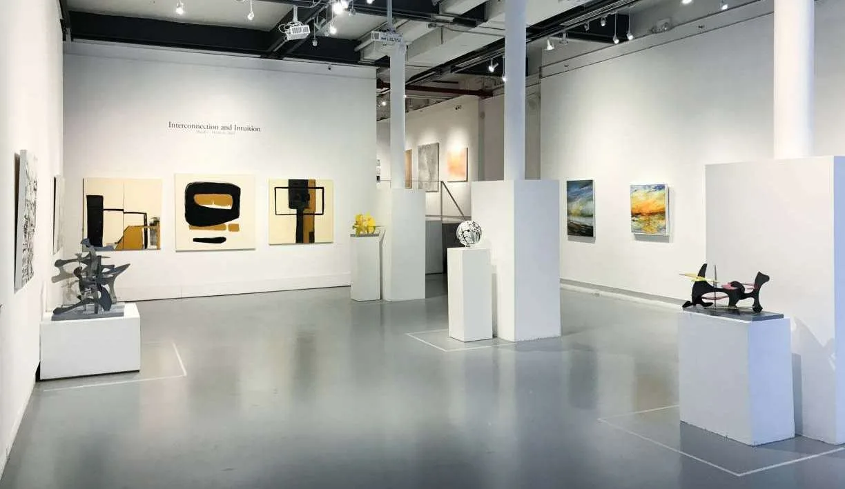 Wide gallery view of an AGI Fine Art exhibition with paintings and sculptures on display