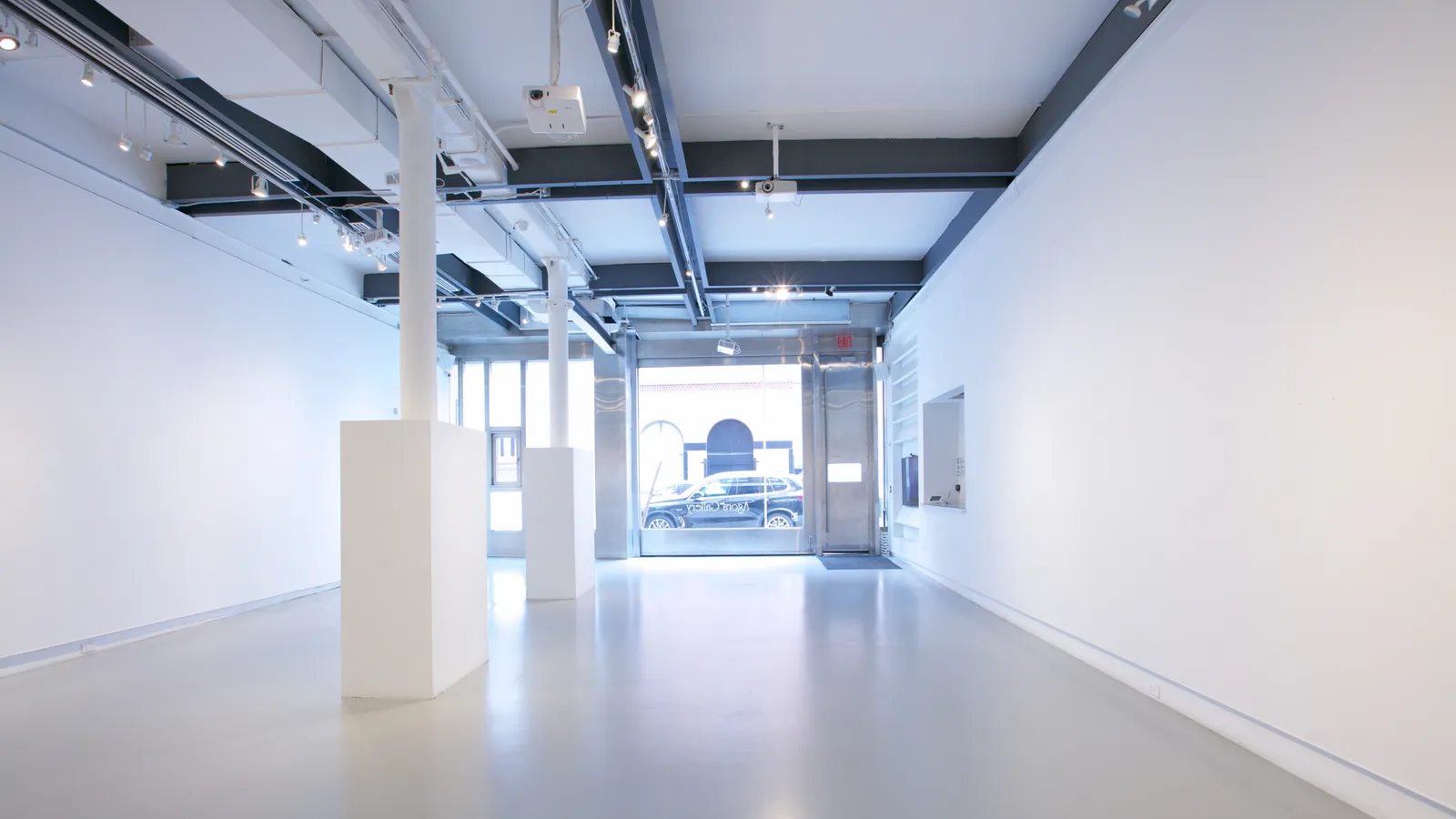 The sliding glass frontage at 530 West 25th Street seen from inside the gallery, opening straight onto the street