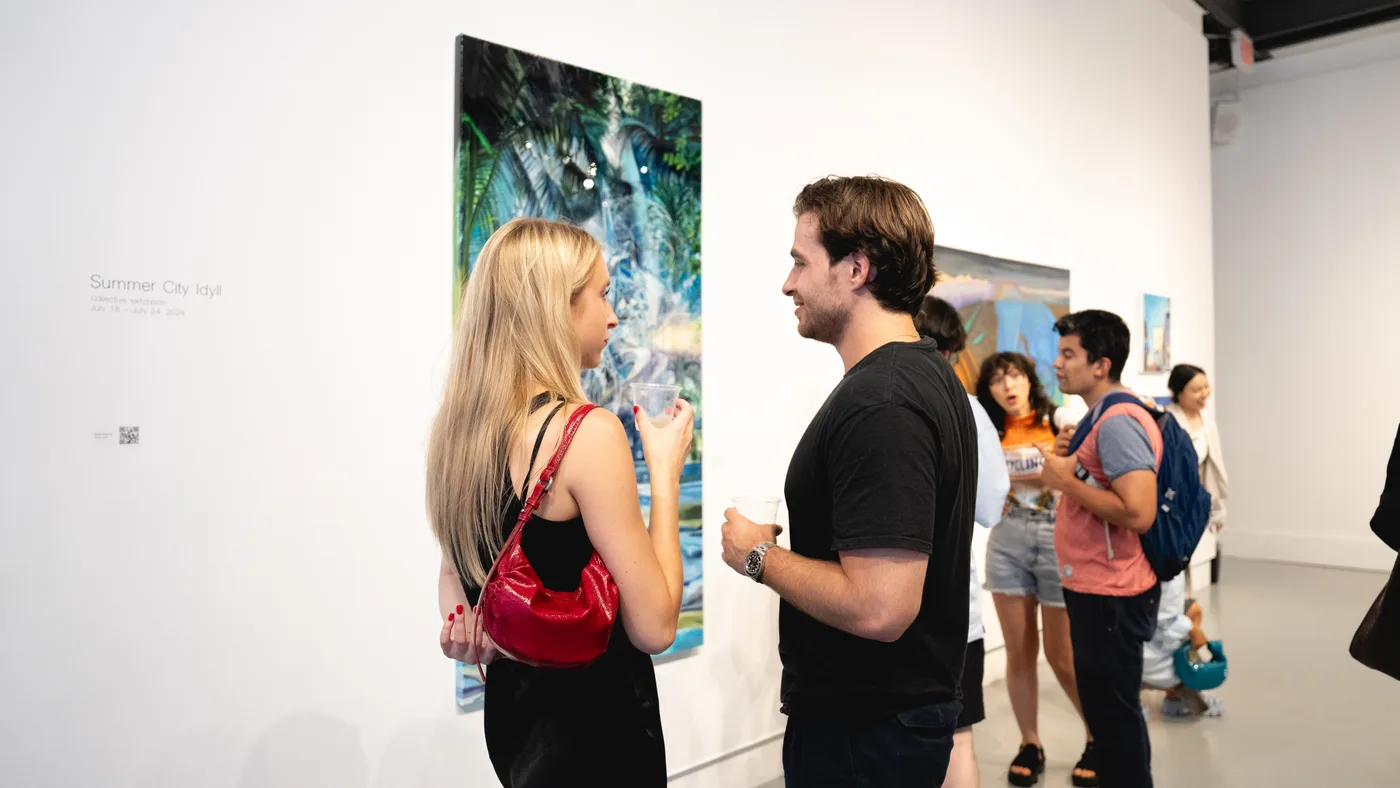 Guests in conversation beside the Summer City Idyll title wall at the opening reception, Agora Gallery, July 2024