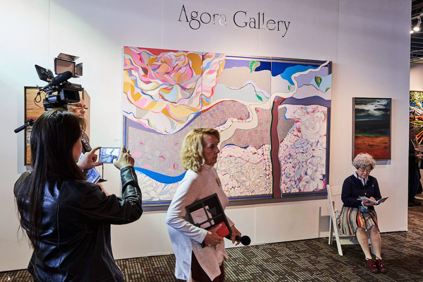 Un camarógrafo en el stand de Agora Gallery en Artexpo Nueva York