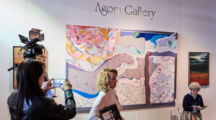 A videographer in Agora Gallery’s booth at Artexpo New York