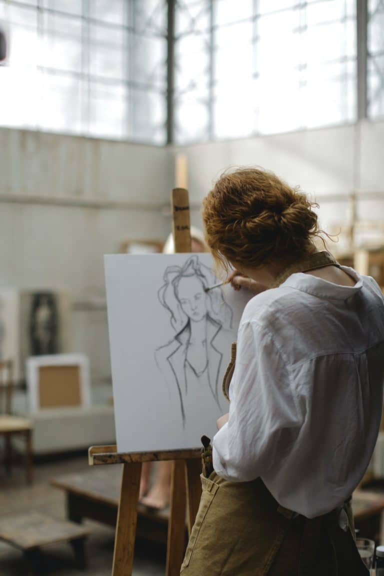 A woman painting on a small canvas