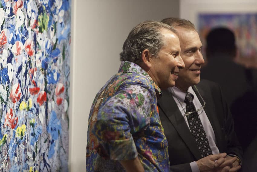 Artist Mark Schiff with guest at opening reception