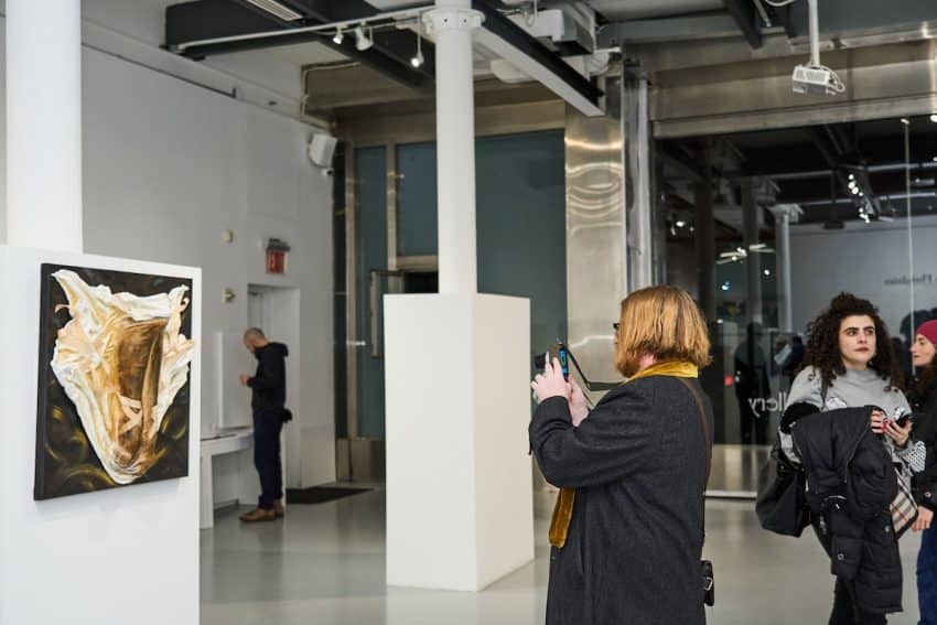 visitor photographing artwork