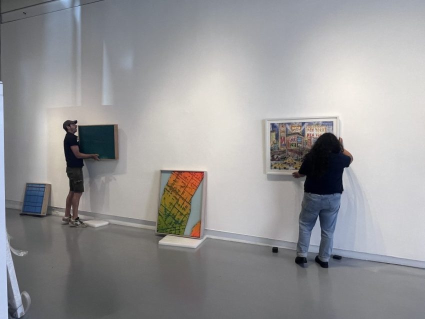 AGI Fine Art staff installing artworks