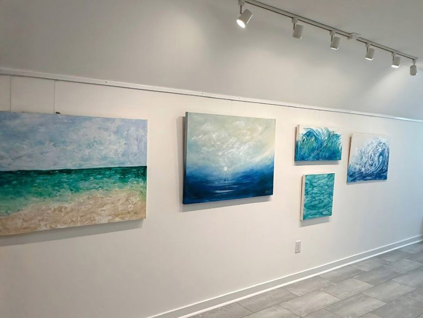 Paintings displayed on the walls of artist Sherri Springer’s home studio