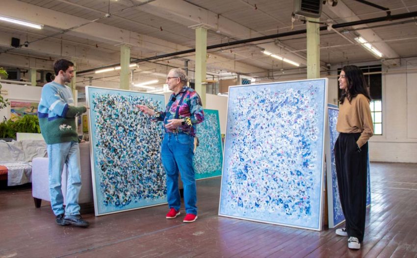 Agora artist Mark Schiff discussing artwork with gallery professionals during a studio visit.