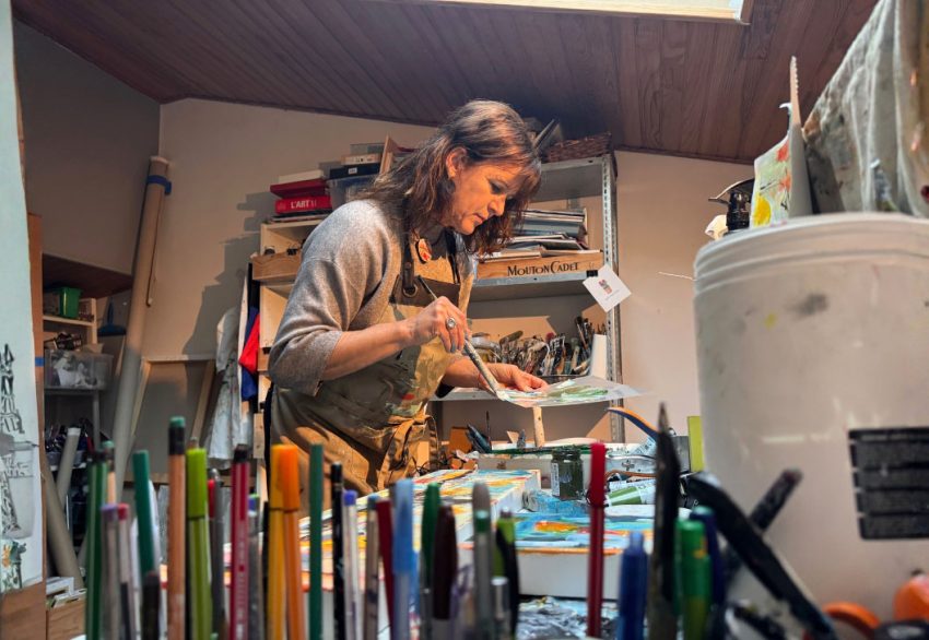 Isabelle De Marco painting in her studio during her creative process.