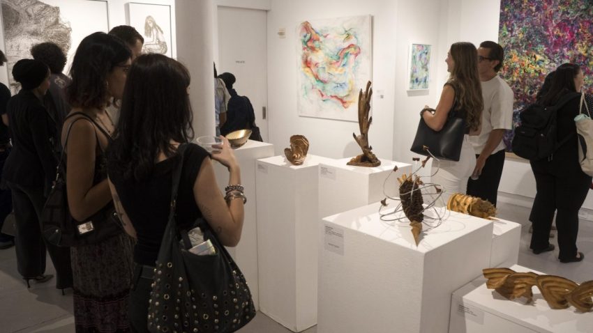 Art collectors and guests attending the Summer City Idyll opening reception at Agora Gallery.
