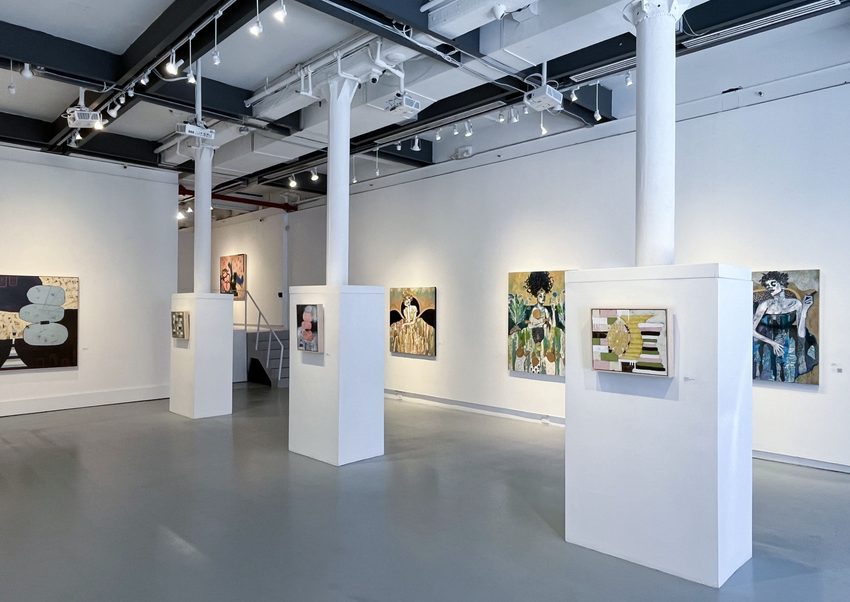 Modern gallery installation showing artwork displayed on white walls and pillars at Agora Gallery.