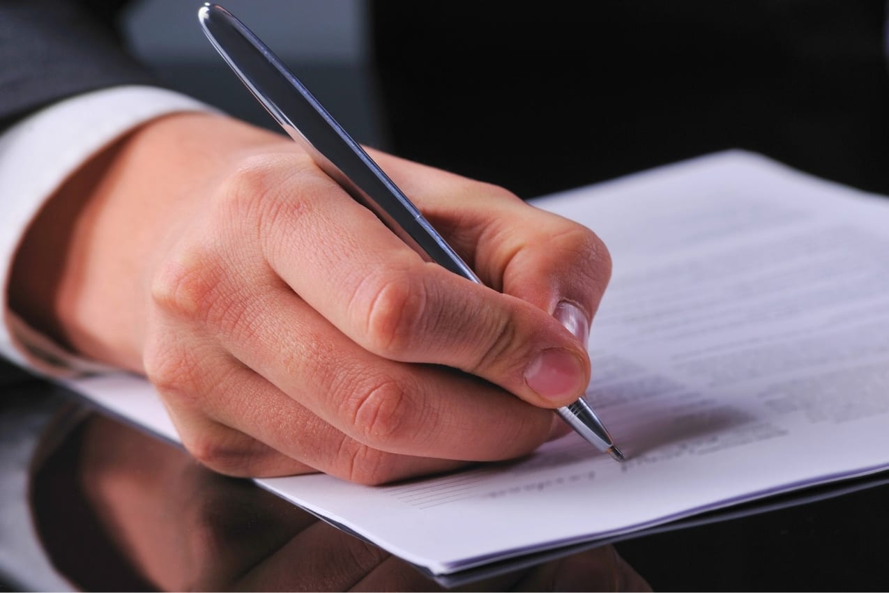 Hand writing a sales record to document an artwork purchase agreement