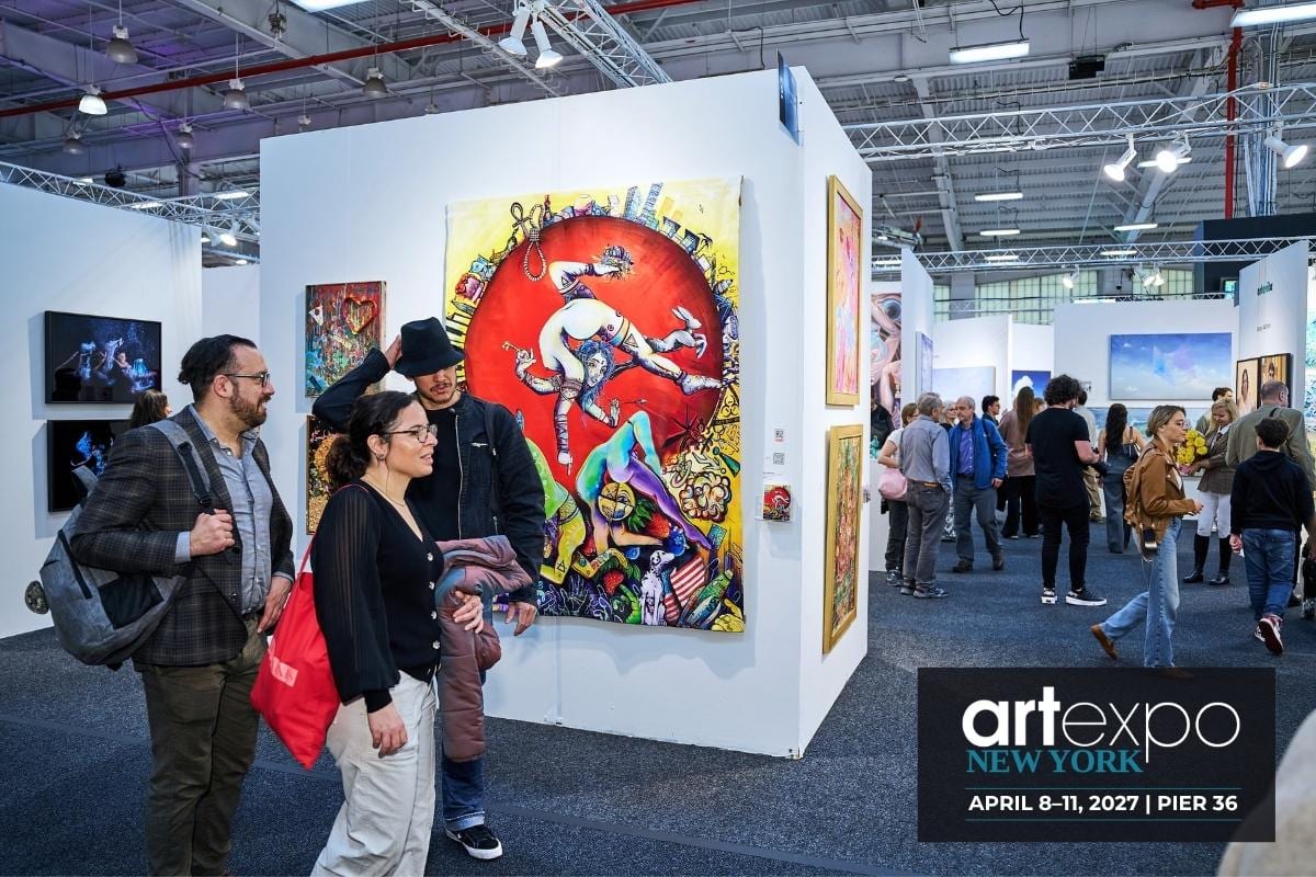 Visitors gather beside a large, colorful painting at AGI Fine Art’s booth at Artexpo New York